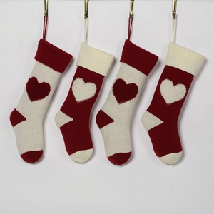 Set of 4 knitted Christmas stockings in red and off-white with 3D heart patterns