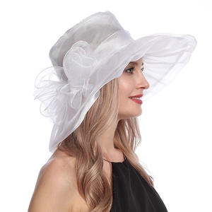 Detail of white organza sun hat featuring elegant layered mesh flower for wedding events
