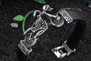 Macro shot of punk rocker motorcycle skull bracelet with vintage silver finish and leather