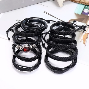 Black woven leather bracelet set for couples featuring a red and black spider emblem charm