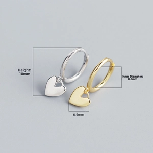 Detailed view of silver and gold heart pendant hoop earrings with 18mm height dimension