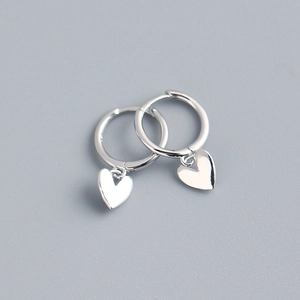 Macro detail of S925 sterling silver heart hoop earrings with a polished silver finish