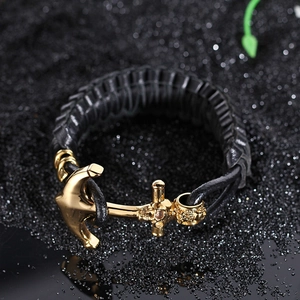 Men's braided leather bracelet featuring a gold stainless steel anchor clasp on dark stones