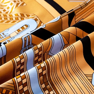 Detailed close-up of the silk twill fabric with classic horse harness and buckle prints