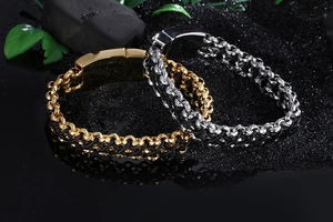 Detail of woven leather bracelets with gold and silver magnetic steel clasps on black stones