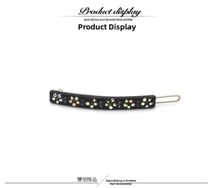 Detail of black acetate hair clip featuring colorful rhinestone flower embellishments