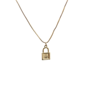 Close-up of a gold-plated box chain necklace with a cubic zirconia micro-pave lock pendant