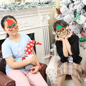Christmas elf glasses frames with green sequins and elf ears worn by kids in festive setting