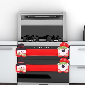 Detail of Christmas snowman and bear covers on modern oven and fridge handles