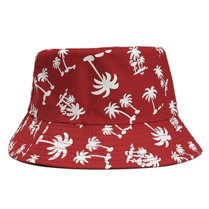 Detail of red bucket hat with white coconut tree prints and neat stitching