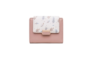 Close-up of pink and white PU leather short wallet with leaf print and gold buckle