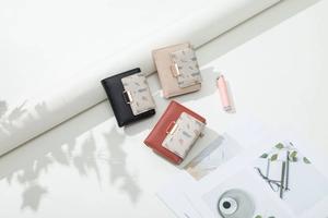 Flat lay of colorful PU leather wallets with leaf pattern and snap button closure