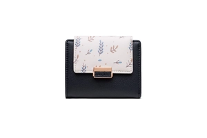 Detail of bicolored PU leather wallet with floral leaf print and gold buckle closure