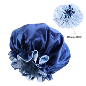 Detailed view of double-layered satin bonnet showing reversible navy and light blue colors