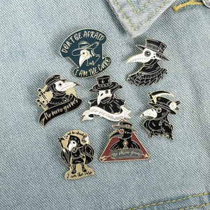 Detail of gothic plague doctor enamel pins on denim with text I Am The Cure