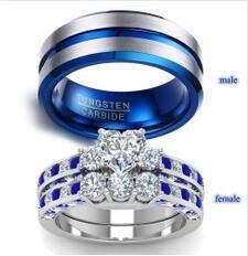 Detail of couple rings showing tungsten carbide band and heart-cut crystal stone