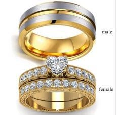 Detail of couple ring set with heart-cut crystal and dual-tone brushed silver band