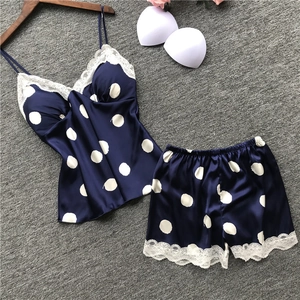 Detail of navy blue polka dot satin pajama set with delicate white lace trim