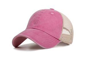 Close-up of pink washed cotton and beige breathable mesh fabric on a baseball cap