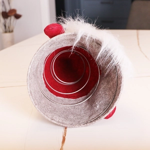 Felt gnome Christmas tree topper with red spring interior and plush white pom-pom detail
