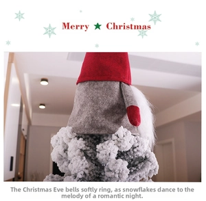 Detail of Christmas tree topper gnome with a red pointed hat and grey plush outfit decoration