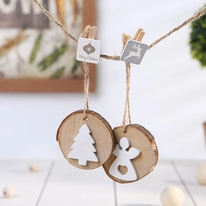 Hanging wooden Christmas ornaments with tree and angel motifs on natural round wood slices