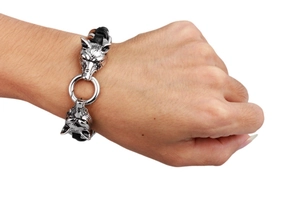 Detailed view of punk wolf head leather bracelet on wrist with polished silver connectors