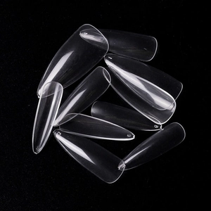 Macro shot of clear long stiletto fake nail tips with size numbers on black background