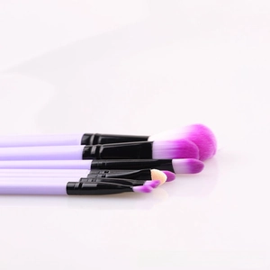 Detail of lavender makeup brush set with black metal ferrule and purple gradient bristles