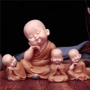 Set of four ceramic little monk car dashboard ornaments with cute nodding expressions