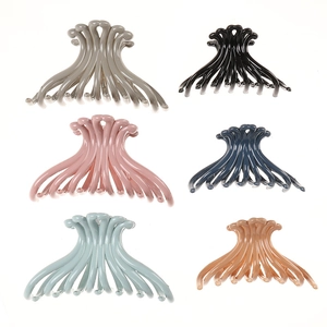 Set of six large geometric matte hair claw clips in various colors on white background