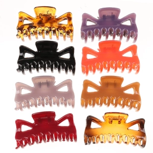 Set of eight hollow geometric hair claws in various colors like amber and black