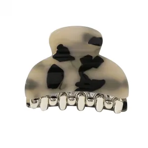 Detailed view of acrylic hair claw clip with black and white tortoiseshell pattern