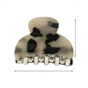 Detailed view of spotted acrylic hair claw clip with measurements and metal teeth