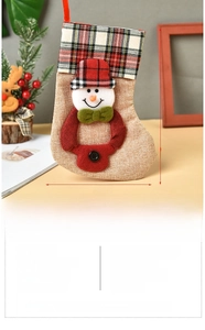Detail of burlap Christmas stocking with 3D snowman doll and red plaid cuff for gifting