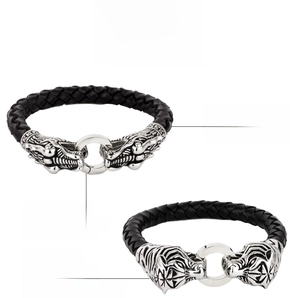 Detail of 316L stainless steel dragon and tiger head clasps on braided leather bracelets