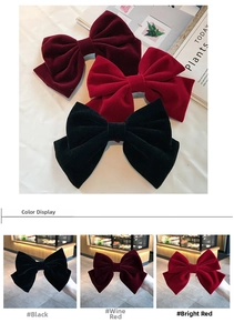 Detail of large velvet bow hair clips in black and red with high quality texture