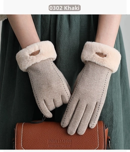 Close-up of khaki winter gloves with plush faux fur cuffs and elegant topstitching