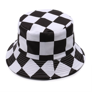 Close-up of black and white checkerboard pattern on a cotton canvas bucket hat