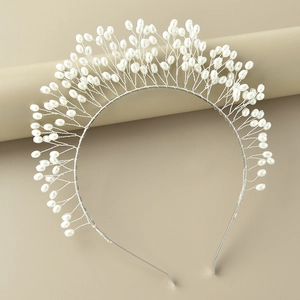 Detail view of silver metal wire headband with white rice pearl embellishments