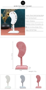 Detailed view of ear-shaped velvet earring display stands in three colors with measurements