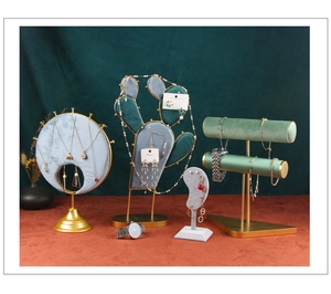 Detail of velvet jewelry display stands with cactus and moon shapes for earring organization