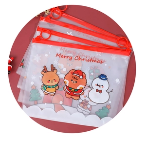 Detail of transparent Christmas folders with red zippers and cute cartoon reindeer prints