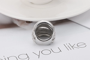Macro shot of a luxury wide-band ring with multi-layer pave cubic zirconia diamonds