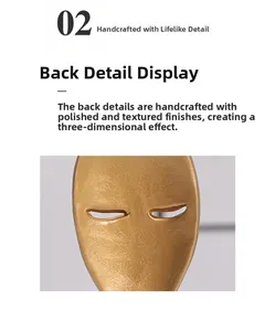 Close-up detail of handcrafted golden abstract face mask showing the textured back finish