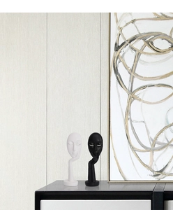 Close-up of minimalist black and white abstract face sculptures in a home decor setting