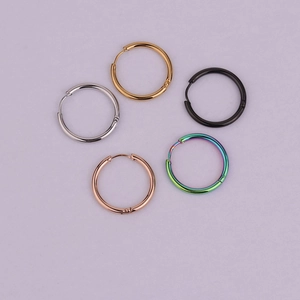 Set of five minimalist stainless steel hoop earrings in gold, silver, black, and rose gold