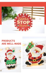 Detail of wooden Santa Stop Here sign with warm LED lights and gold texture finish