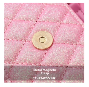 Macro shot of gold metal magnetic clasp and quilted pink sequin fabric on girls' handbag