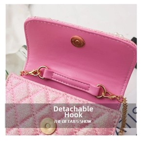 Detail of pink glitter mini bag with detachable gold chain and pearl embellishments